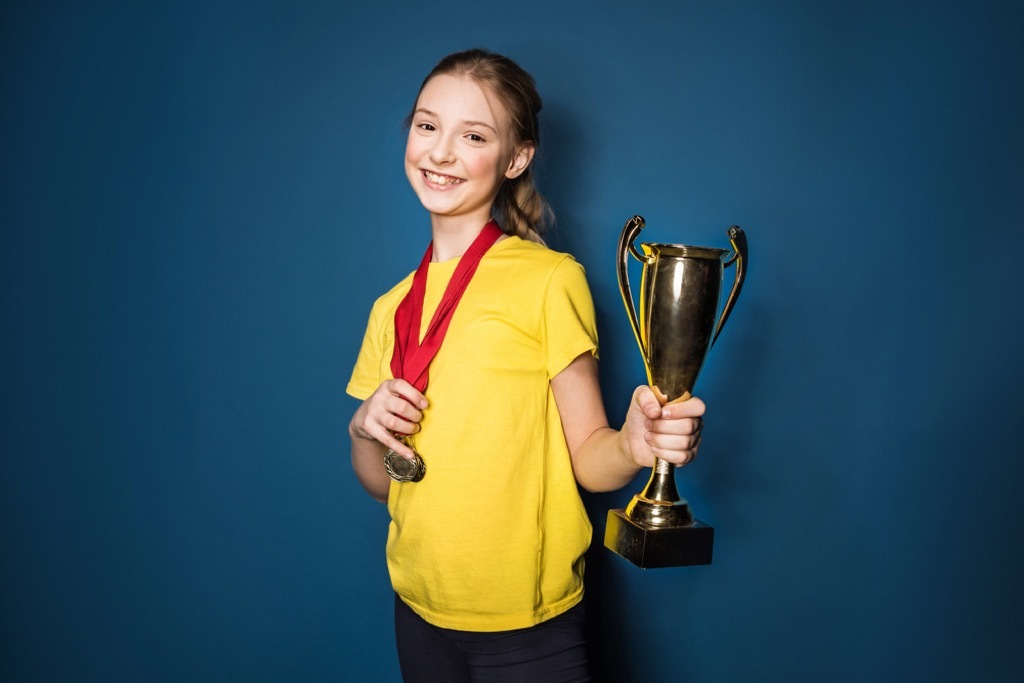 girl holding medal