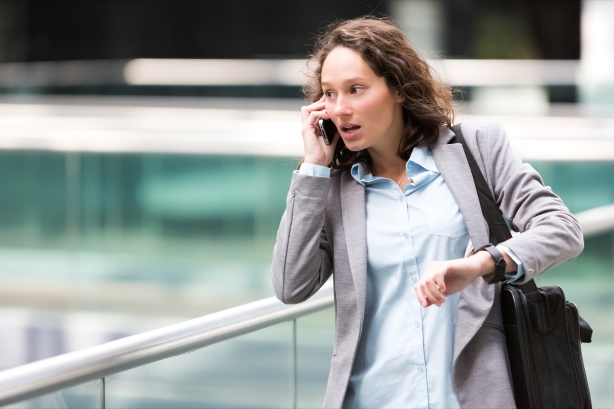 Woman in a hurry looking at her watch.