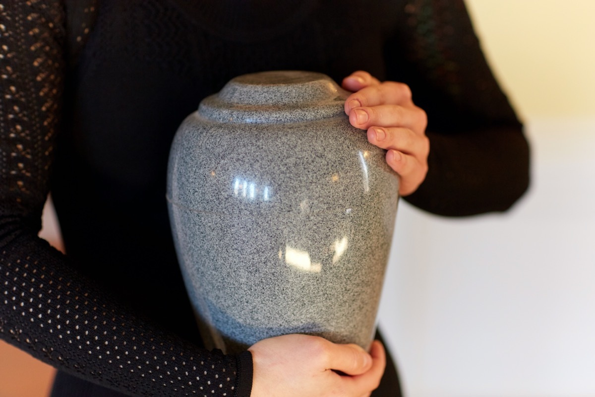 woman holding funerary urn