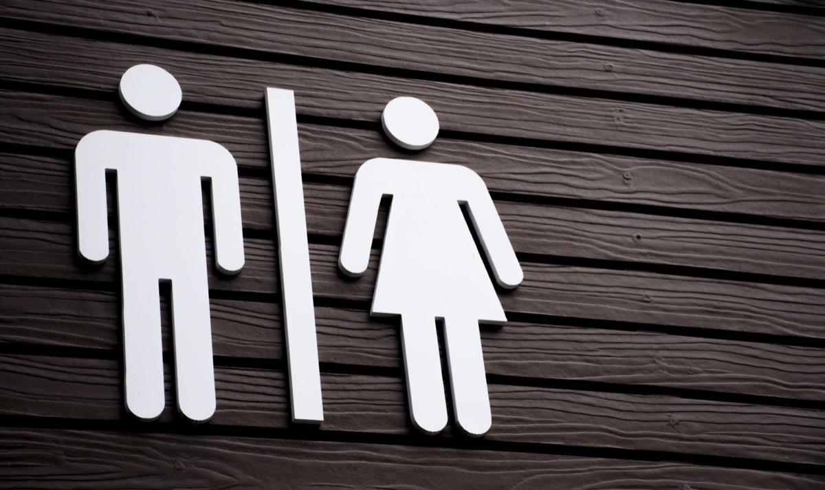 Restroom sign on a toilet door,on wood background