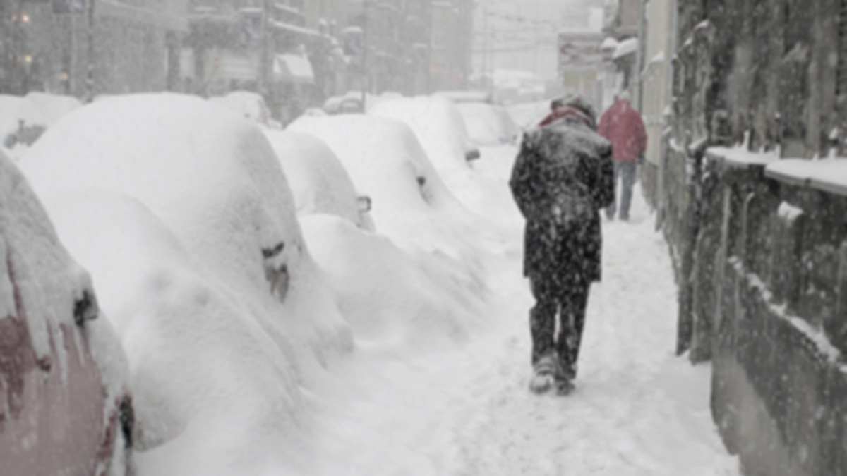 man walking in snowstorm