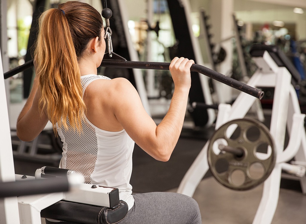 Woman doing lat pulldown at gym