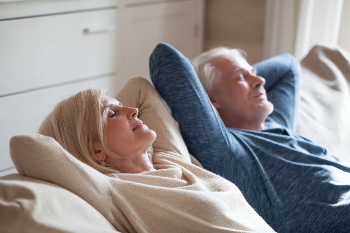 Older couple relaxing on couch