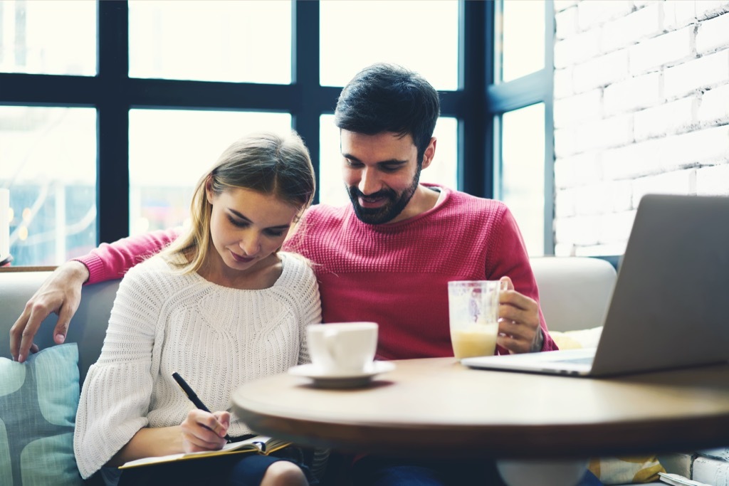 couple writing things down at a coffee shop, open marriage