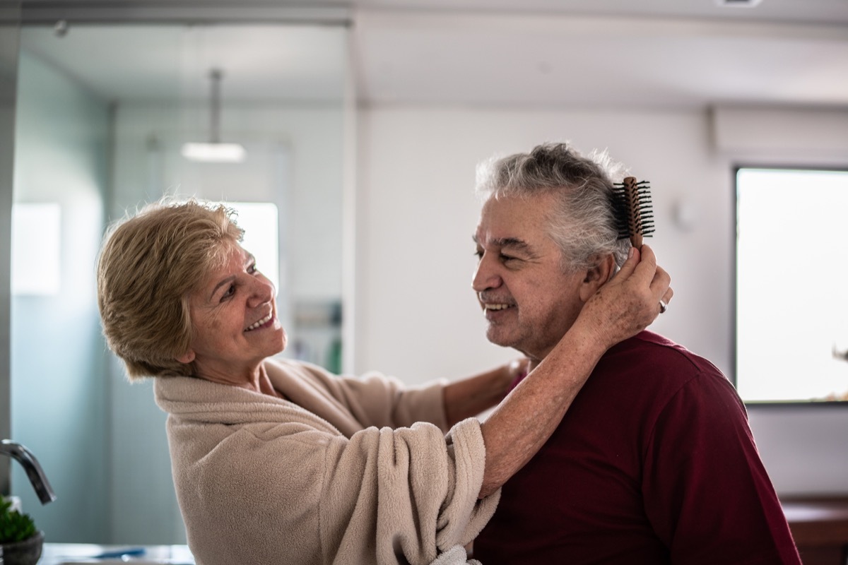 Wife brushing husband's hair