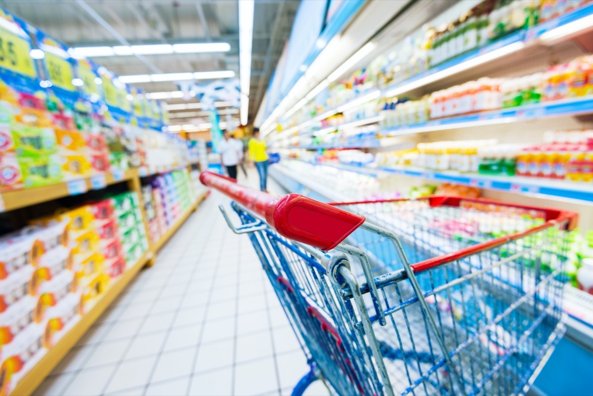 abandoned shopping cart in grocery store aisle