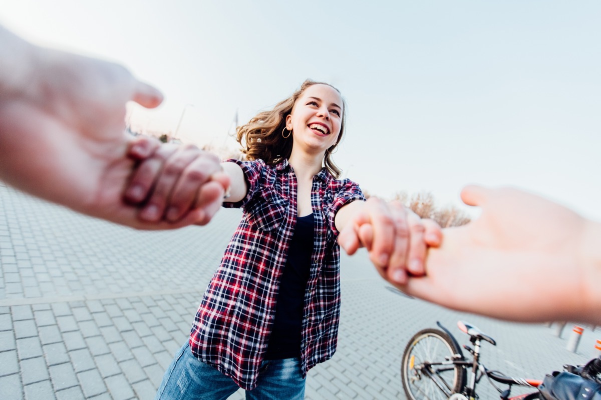 POV shot of girl holding hands with her boyfriend and spinning around