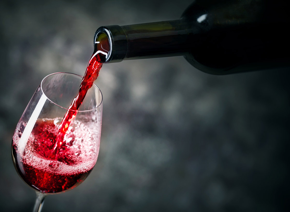 red wine being poured from bottle into glass