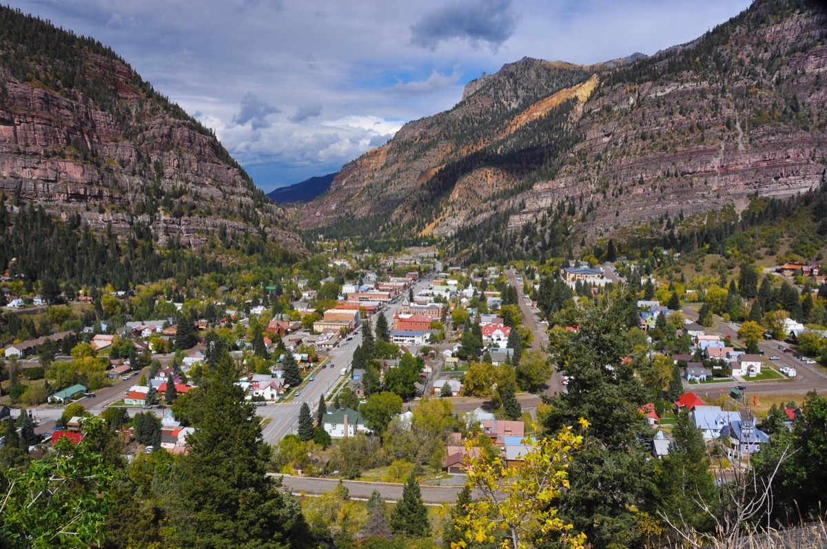 a small town surrounded by brown mountains.