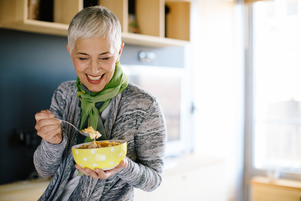 Older woman eating a healthy breakfast.