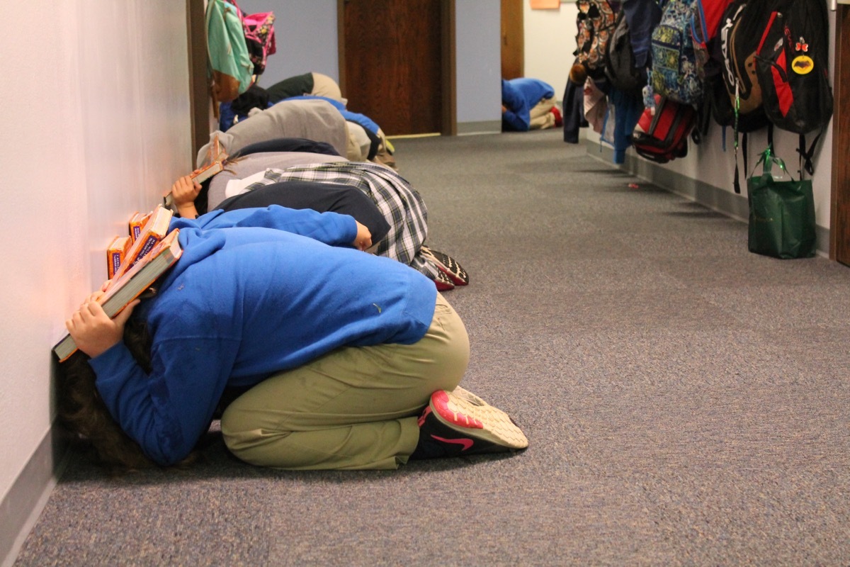 children performing tornado drill