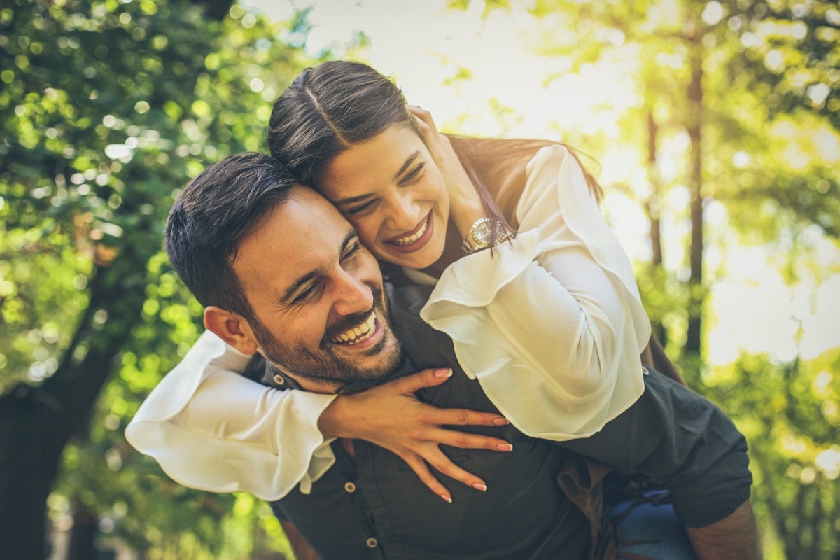 Young man carrying his girlfriend on his back