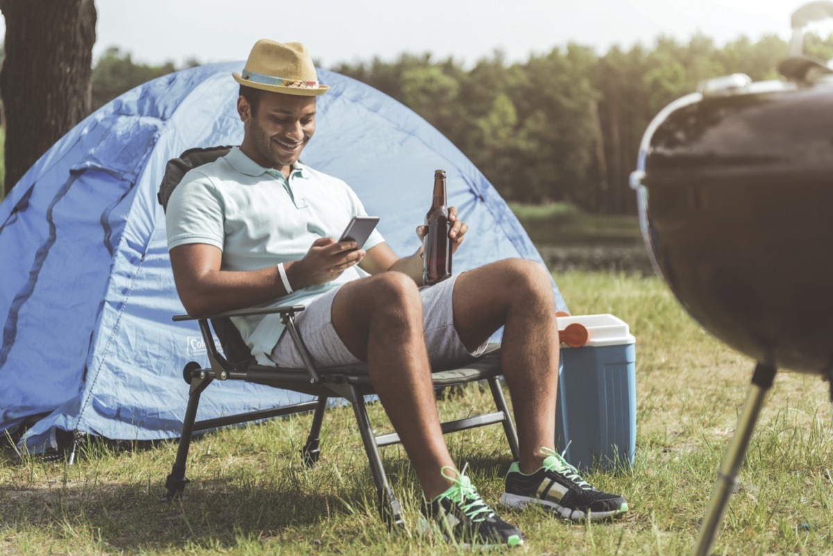 man sitting on foldable chair