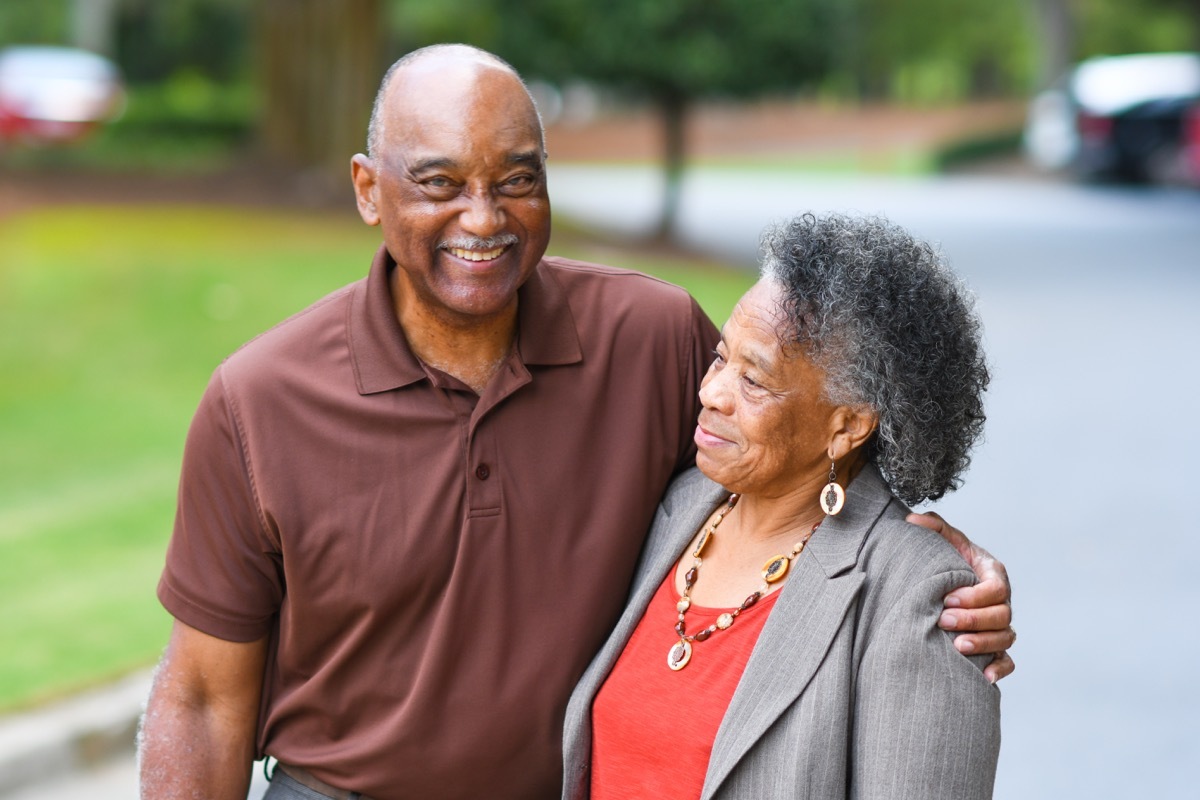 older black couple hugging outdoors