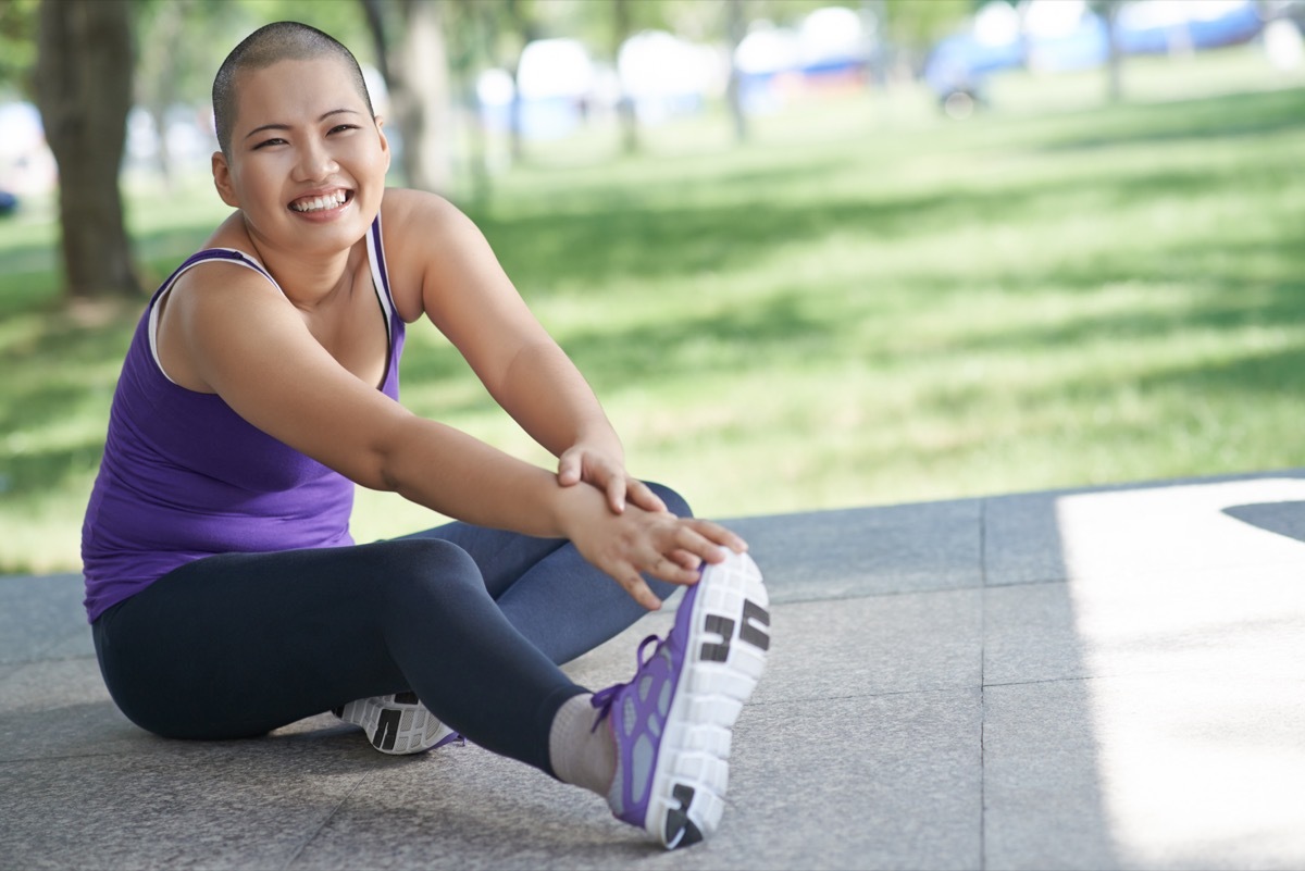 Woman with cancer stretching