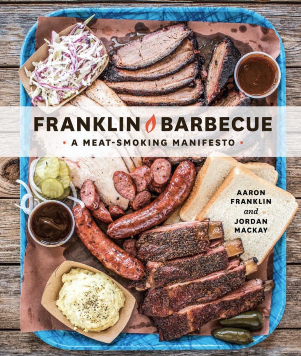 franklin barbecue cookbook with meats and mashed potatoes and pickles and bread on the cover