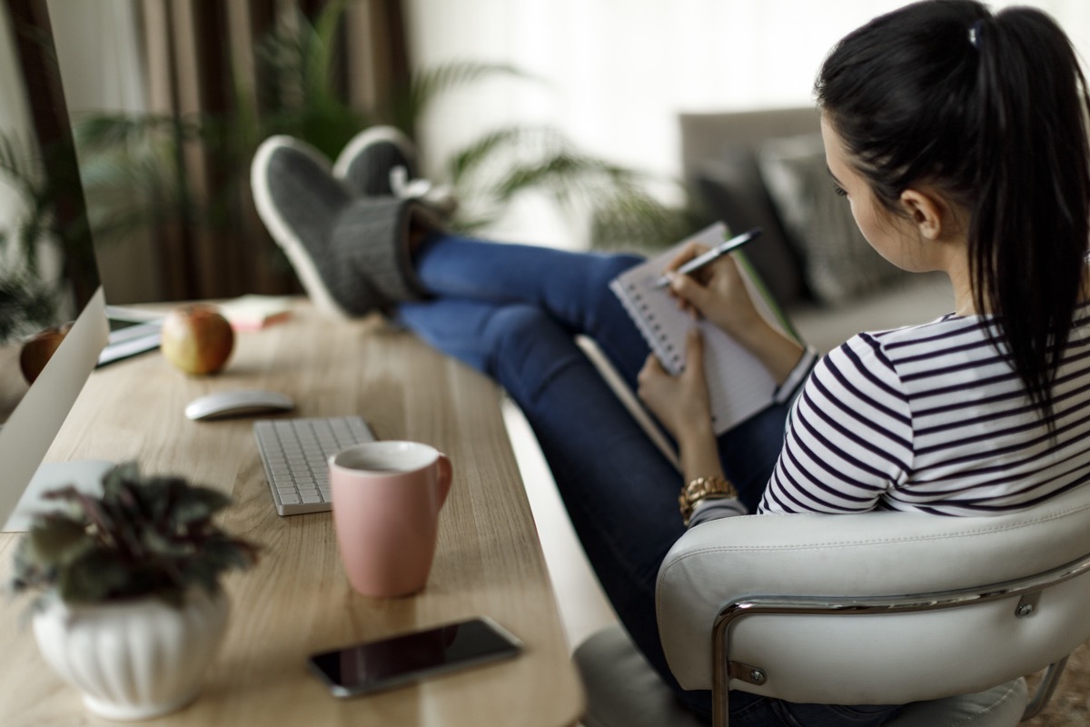 Woman writing in her notebook or journal