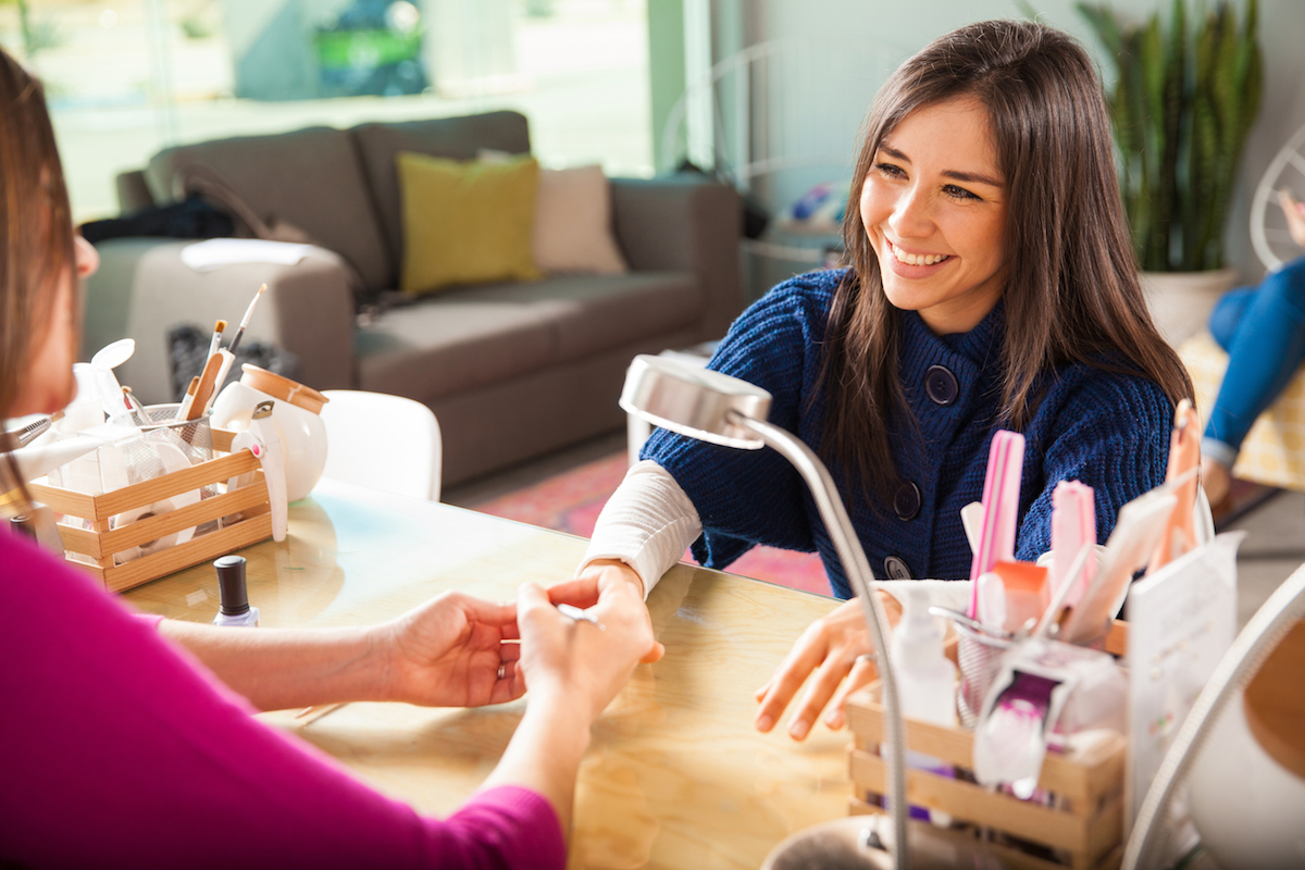 Woman getting manicure