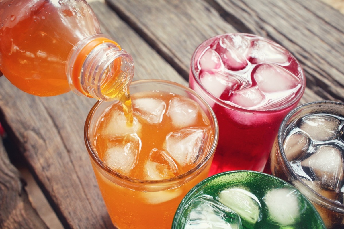 four sodas being poured on a wooden table, who wants to be a millionaire