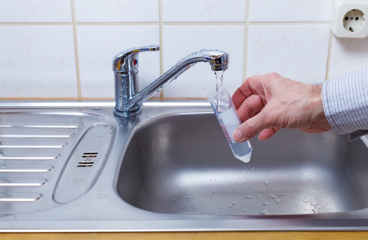 Drinking water in the test tube for chemical and microbiological analysis