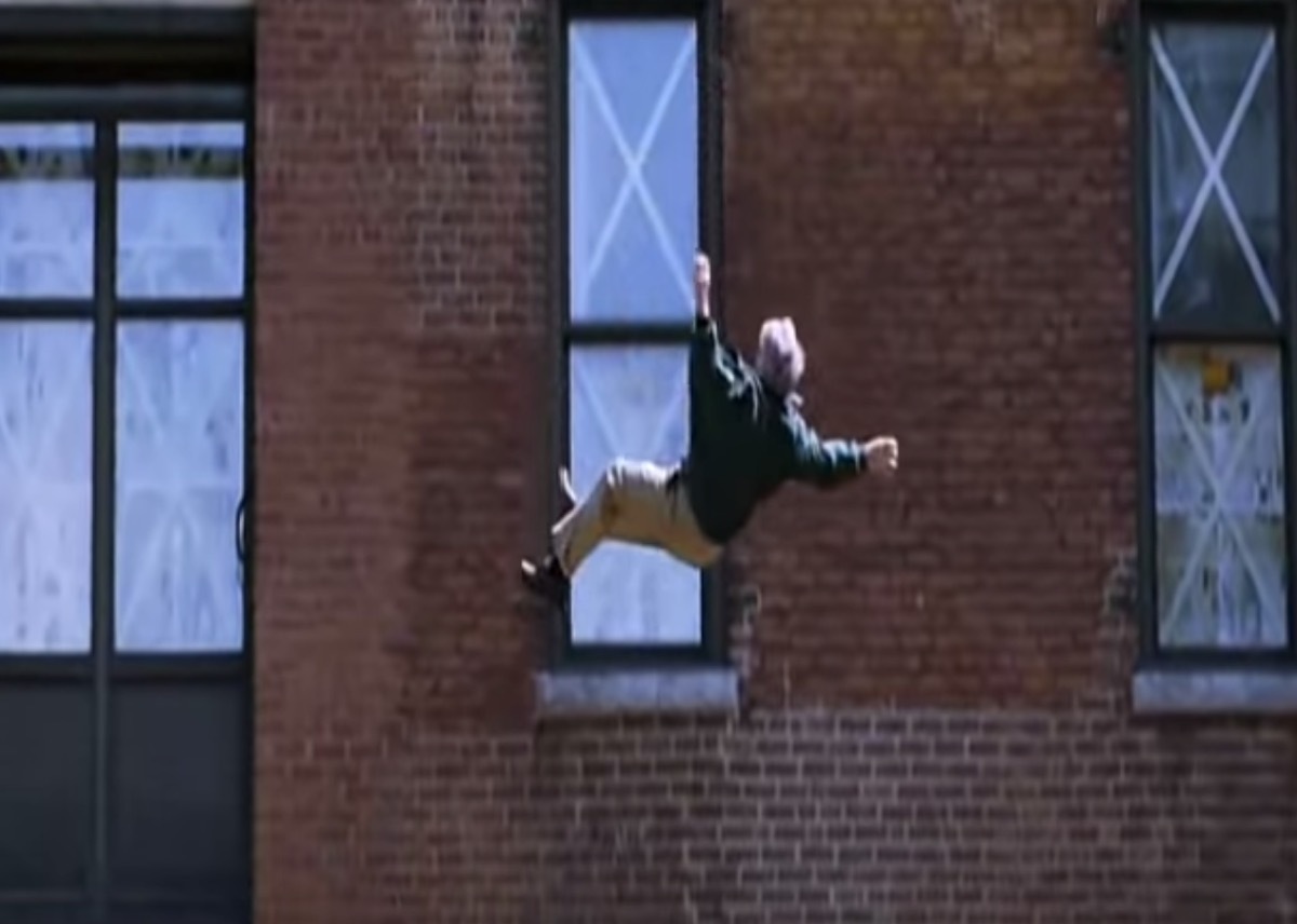 man falling from a building with the letter 