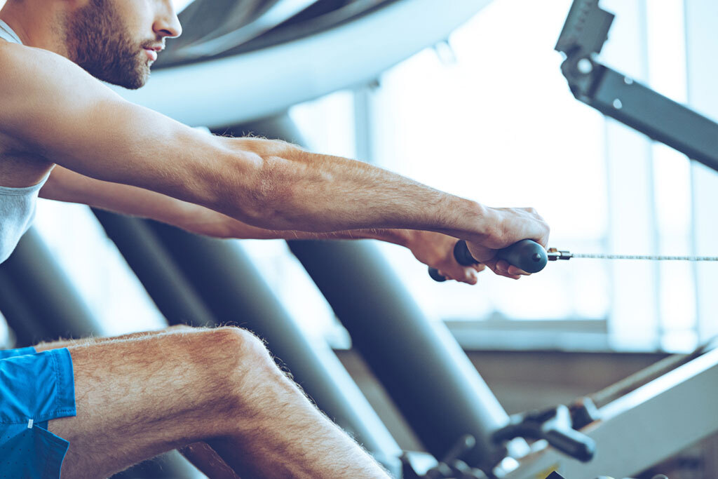 Guy on a rowing cardio machine