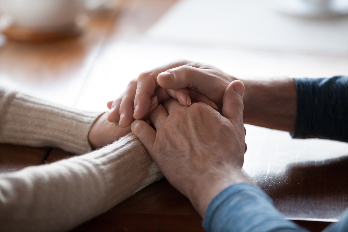 senior people holding hands