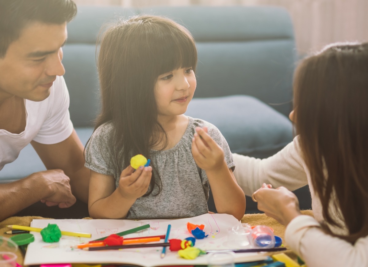 young parents playing with daughter