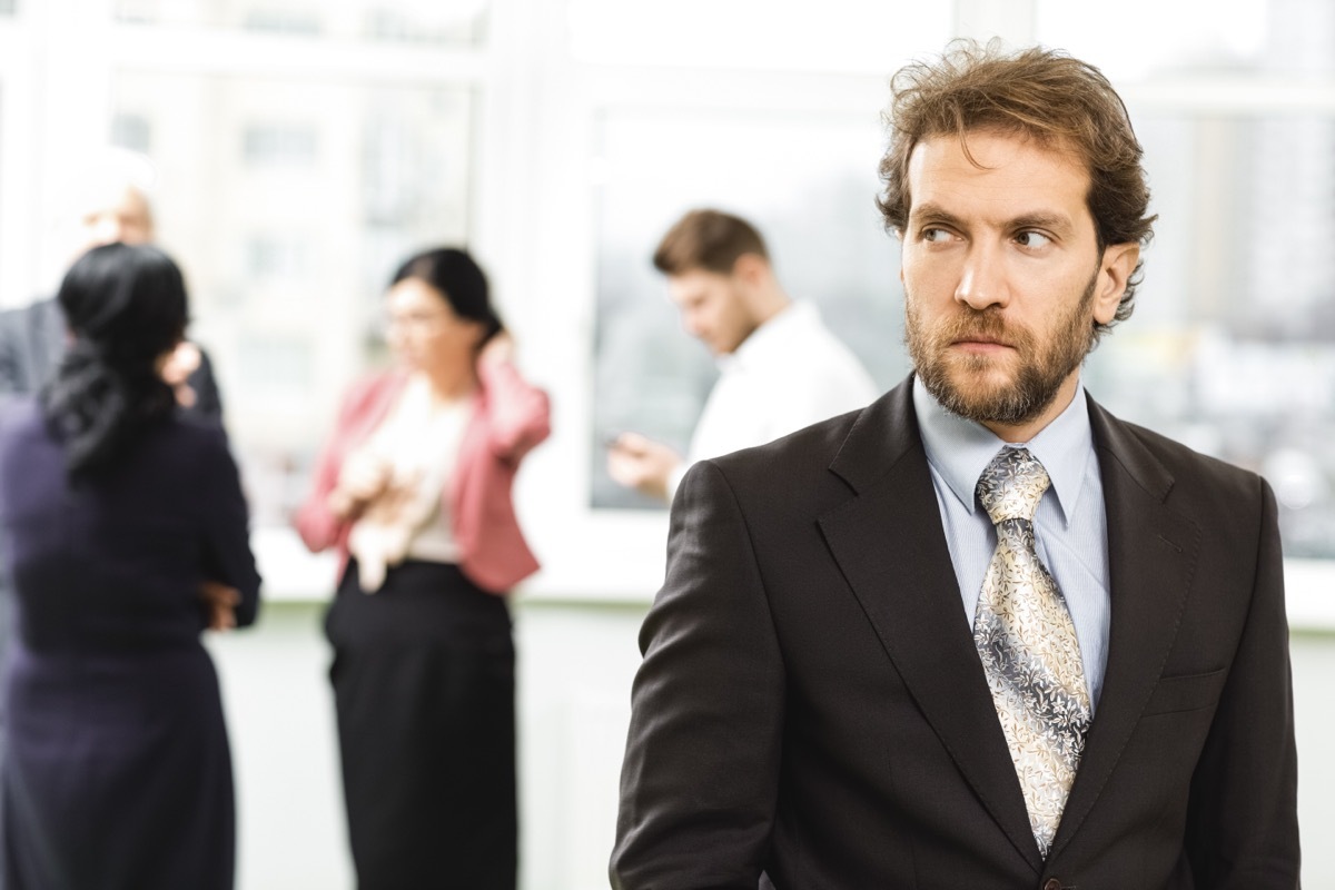 business man looking suspicious of his employees