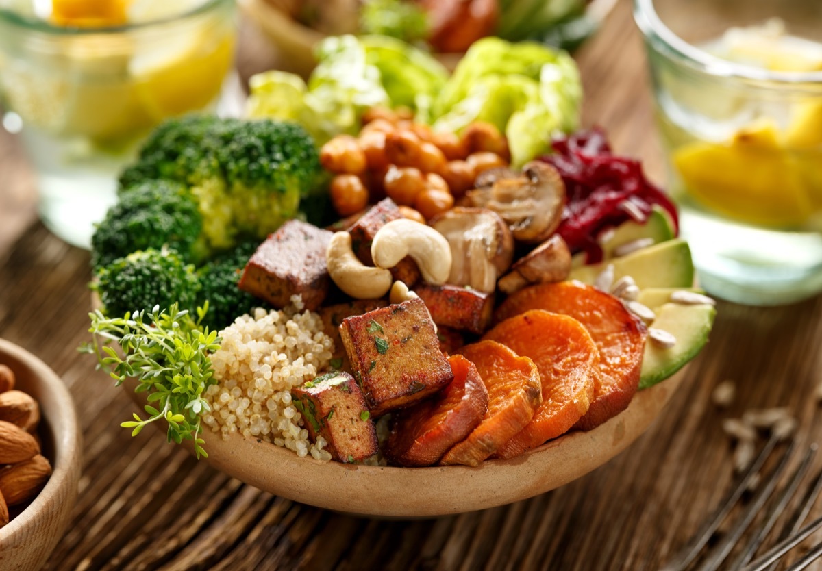 Small plant based, colorful buddha bowl with lemon water