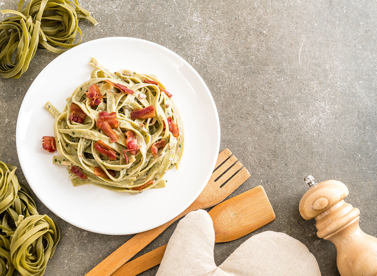 spinach and bacon fettuccine noodles in bowl