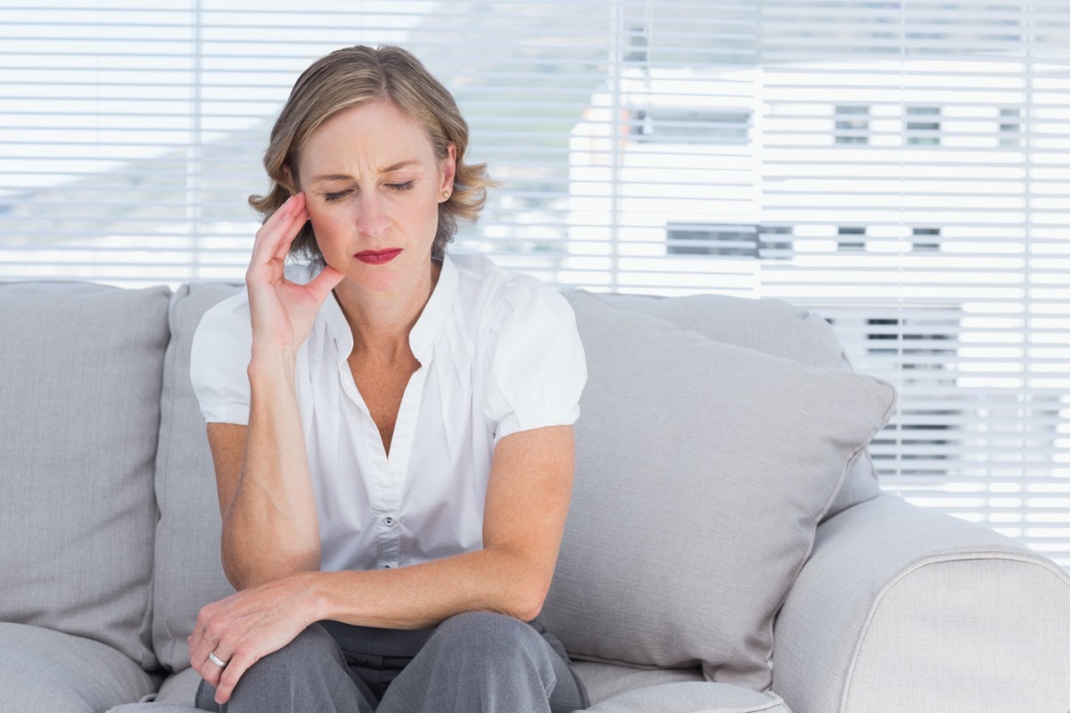 Worried businesswoman sitting on couch