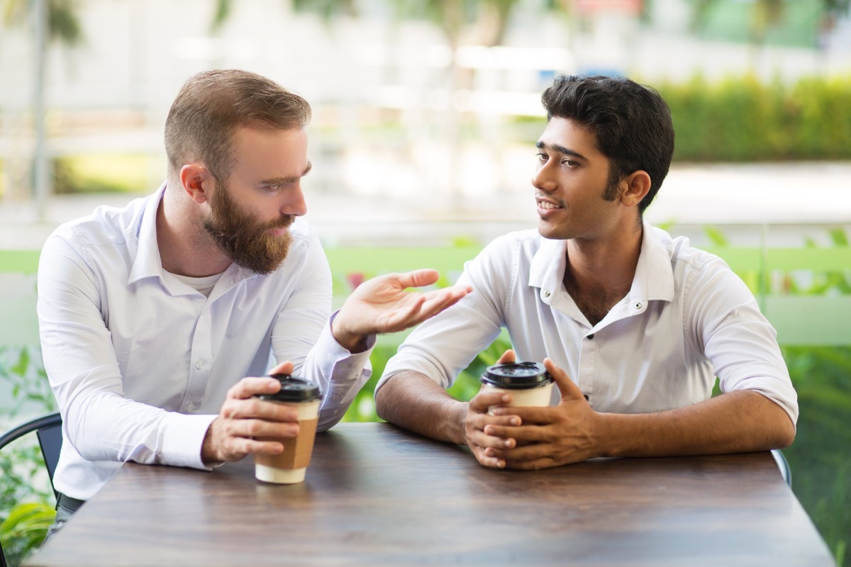 Male friends talking over coffee