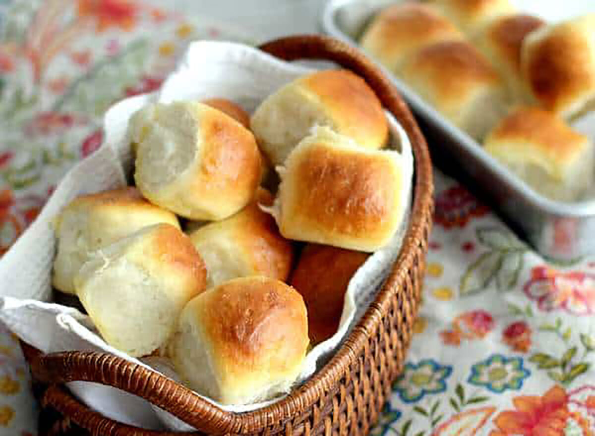 basket of dinner rolls on tablecloth