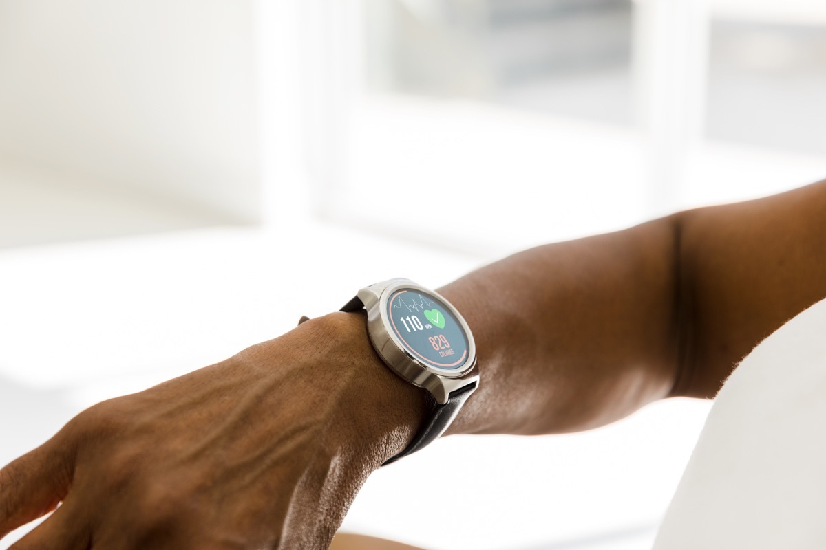 woman checks her heart rate and other activity levels on her smart watch.