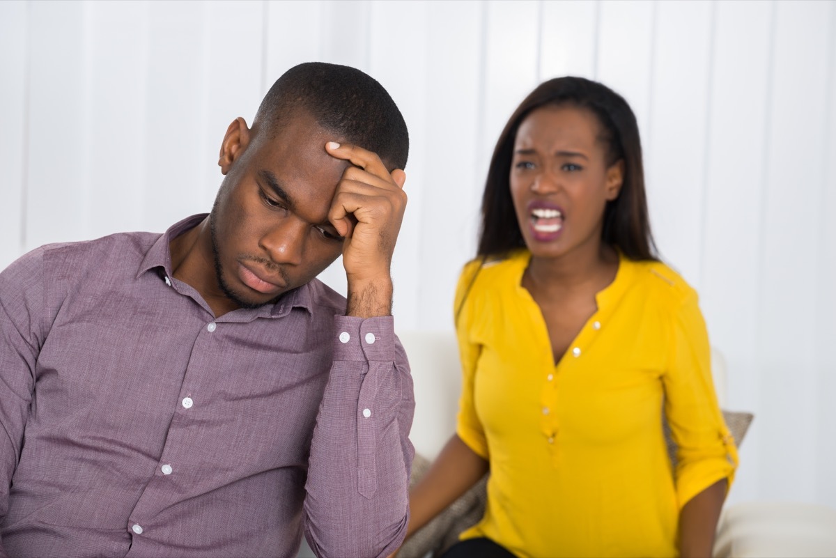 Couple fighting man ignoring woman yelling at him