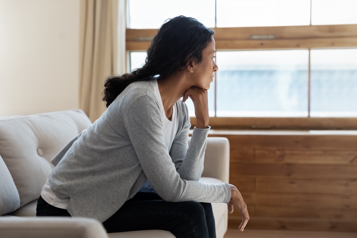 woman sitting on couch alone