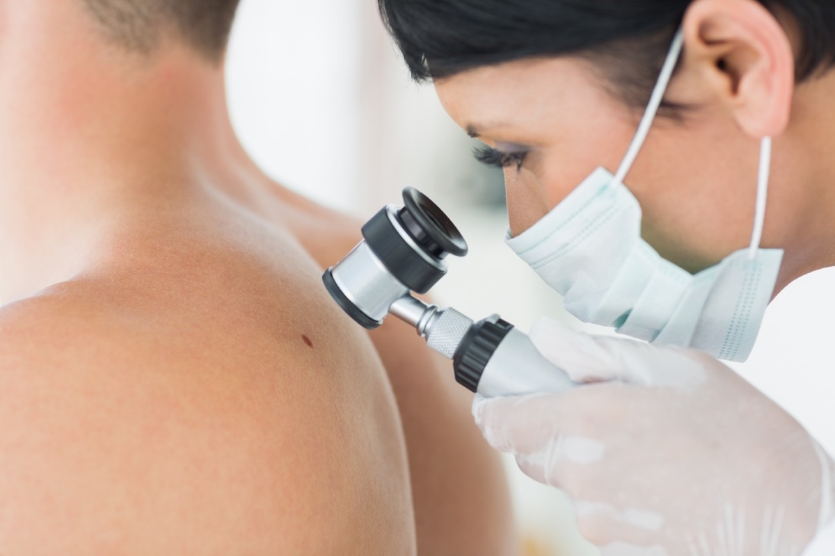 Dermatologist checking patient's skin