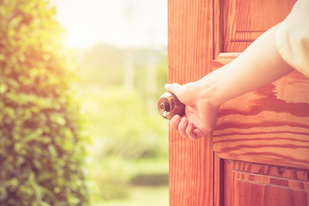 doorknob woman opening door, things you should clean every day