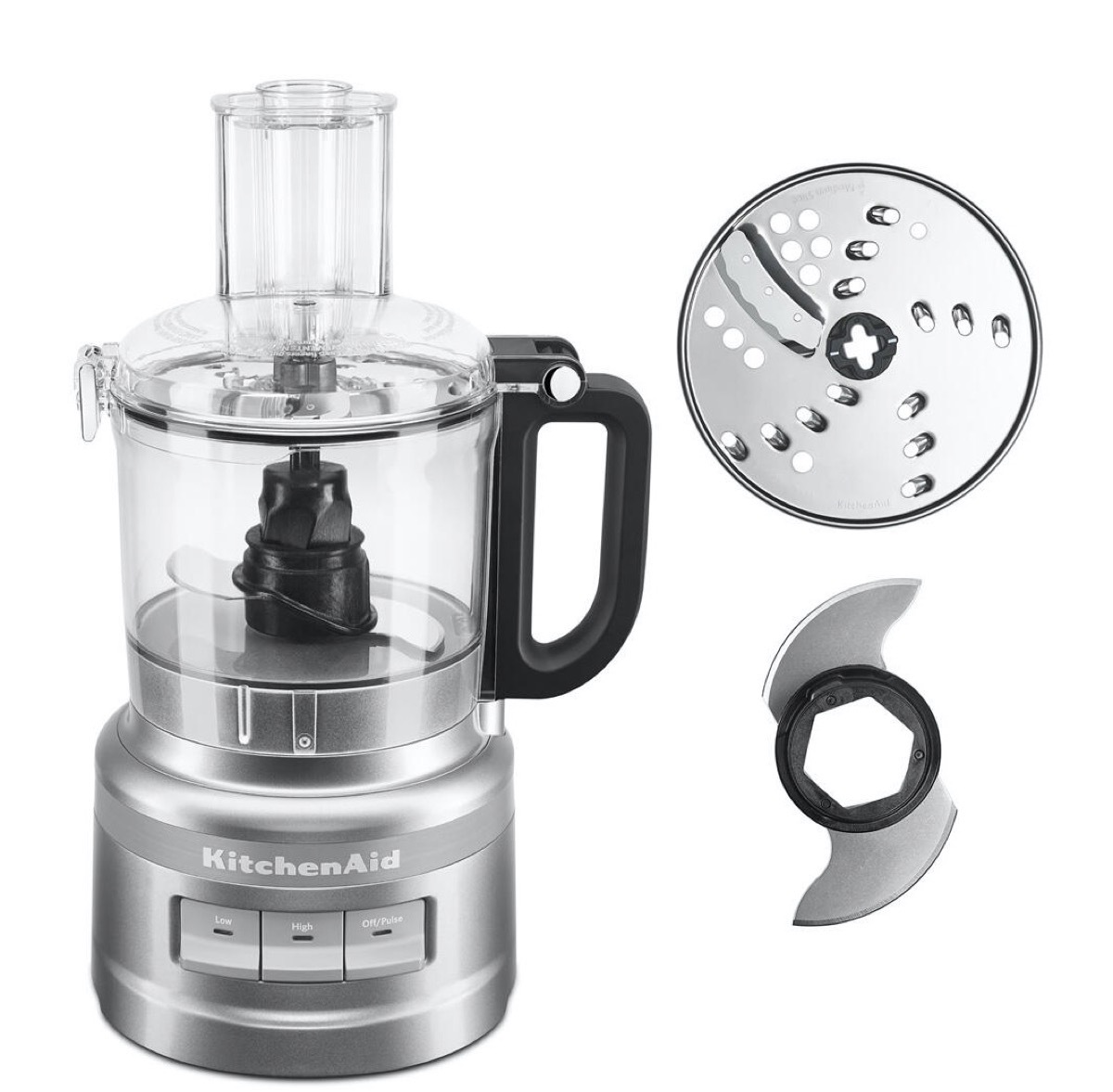 silver kitchenaid food processor next to shredding disc and blade attachment