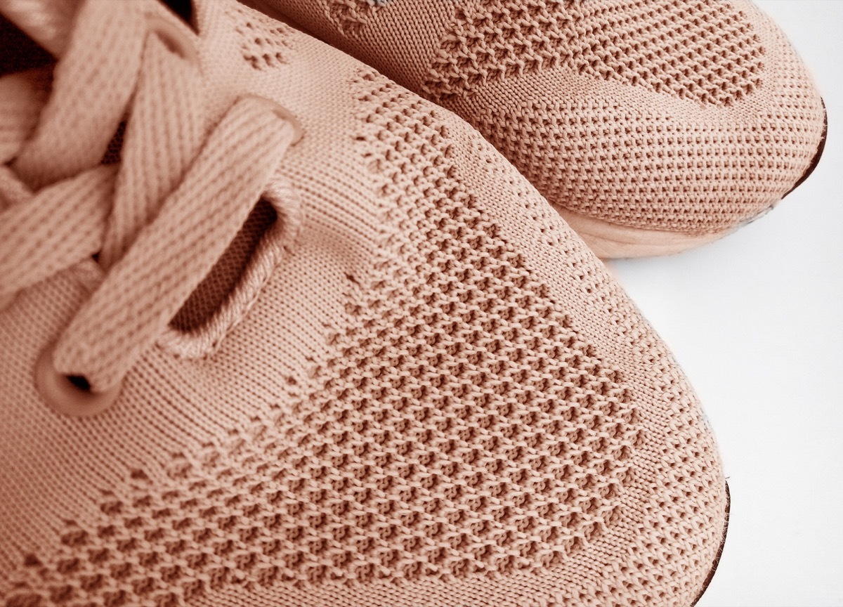 a pair of brown shoes made of rough fabric on a white background. partially sighted image