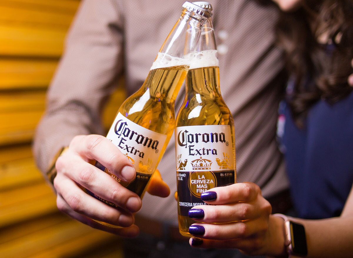 couple holding corona extra bottles most popular beer new york