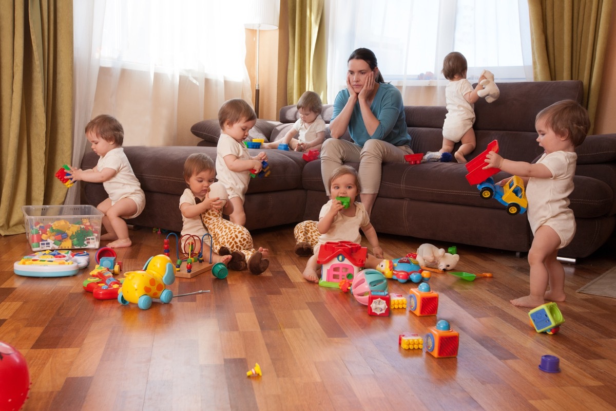 Mim sitting on couch overwhelmed by a lot of kids