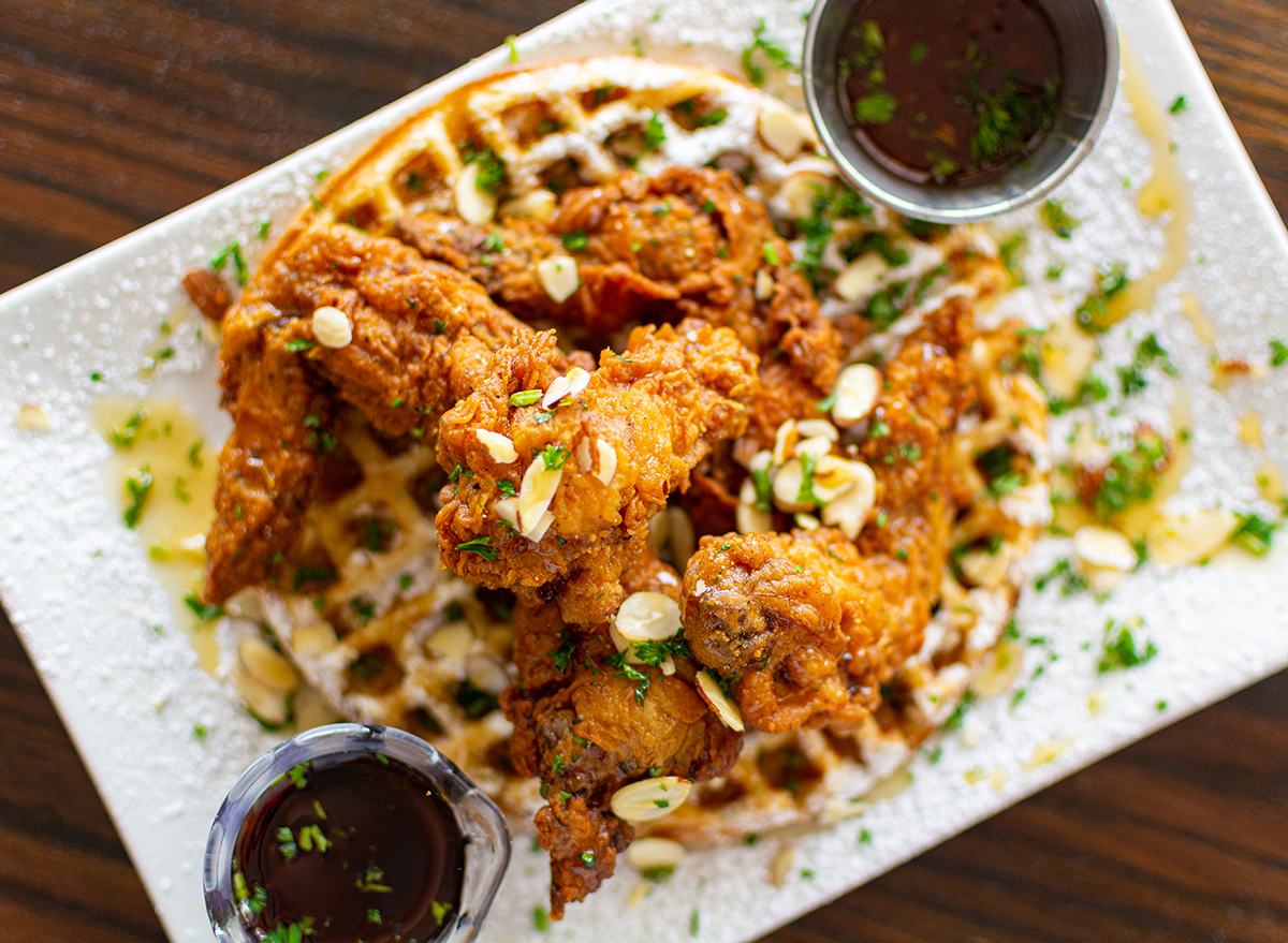 chicken and waffles topped with slivered almonds