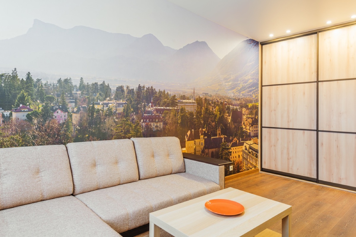 living room with cream couch and wall mural