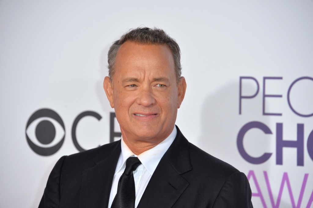 Tom Hanks in suit, half-smiling, celebrity grandparent