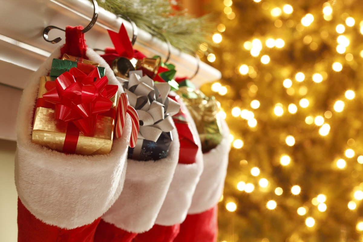 Christmas stockings in front of a blurred Christmas tree.