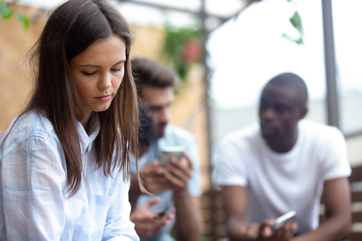 person isolated from group, stress signs