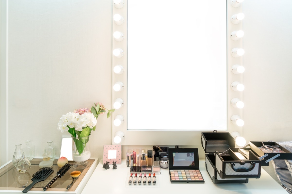 Modern closet room with make-up vanity table, mirror and cosmetics product in flat style house