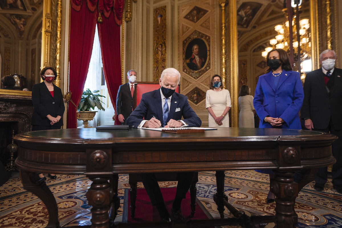 President Joe Biden signs three documents including an Inauguration declaration, cabinet nominations and sub-cabinet nominations, as US Vice President Kamala Harris (R) watches in the Presidents Room at the US Capitol after the inauguration ceremony making Biden the 46th President of the United States on January 20, 2021 in Washington, DC.